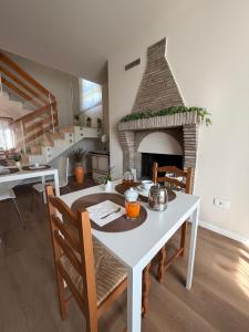 a dining room with a table and a fireplace at Pratelli B&B in Saludecio