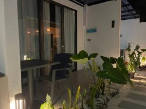 a dining room with a table and some plants at Velaa Dhigurah in Dhigurah +13 photos