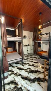 a room with two bunk beds in a room at A Lounge Hostel in Ella