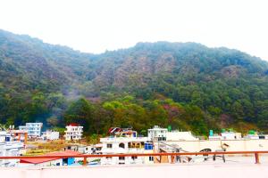 a view of a town in front of a mountain at Kattel HomeStay And Apartments in Bālāju