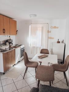 a kitchen with a table and chairs and a refrigerator at Apartment Estera in Jelsa