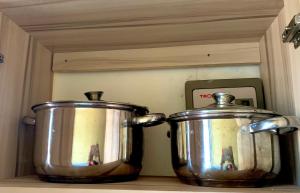 two pots sitting on top of a kitchen counter at Highway sunset in Namulanda