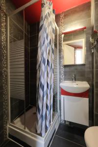 a bathroom with a sink and a shower at Hipotel Paris Gambetta République in Paris