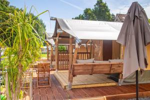 a deck with a gazebo and an umbrella at Camping Neckargemünd bei Heidelberg in Neckargemünd