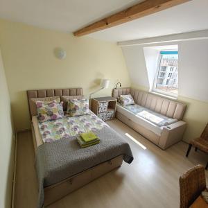 a bedroom with two beds and a window at Willa pod Krokodylem in Łeba