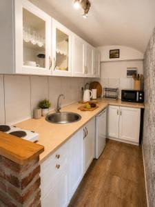 a kitchen with white cabinets and a sink at Ekofarma Selwit in Sosnówka