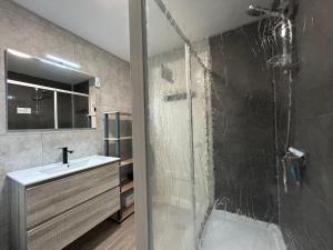 a bathroom with a glass shower and a sink at Appartement RDC Chalet à 300m du lac de Gérardmer in Gérardmer +22 photos