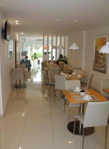 a restaurant with tables and chairs and a dining room at Sea Garden Peniche in Peniche