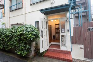 an entrance to a building with a white door at Tokyo Candle house in Tokyo