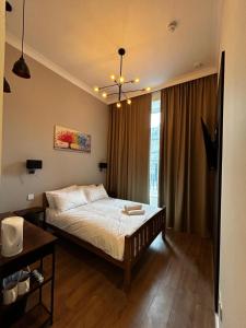 a bedroom with a large bed with a chandelier at Super Nova Self-Service Hotel in Aberdeen +24 photos