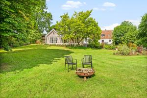 two chairs and a fire pit in a yard at Wild Wilderness in Schaalby