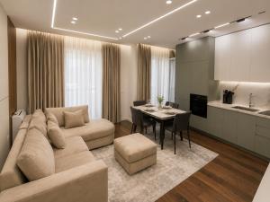 a living room with a couch and a table at Dream Luxury Suite in Tirana