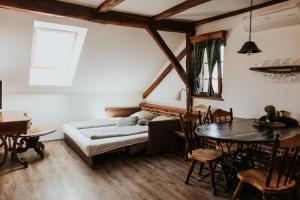 a living room with a bed and a table at RANČ JUREŠ - Relaxing Countryside Escape in Ljutomer