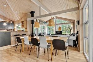 a kitchen and dining room with a table and chairs at 8522-Grenaa-Nobilisvej-15 in Grenå