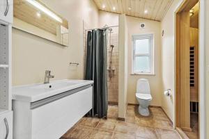 a bathroom with a sink and a toilet at 8522-Grenaa-Nobilisvej-15 in Grenå +23 photos