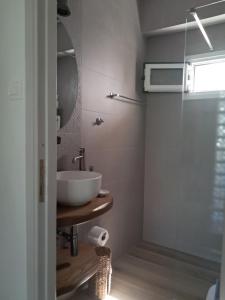 a bathroom with a sink and a mirror at Asprocyclia House in Kalymnos +29 photos
