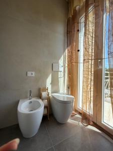 a bathroom with a tub and a toilet and a sink at Pratelli B&B in Saludecio +68 photos