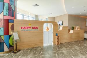 an office with a happy kids sign on the wall at Nha Trang Oceanview Suites in Nha Trang +167 photos