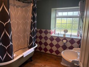 a bathroom with a bath tub and a sink at The Hunters Rest Inn in Clutton +41 photos