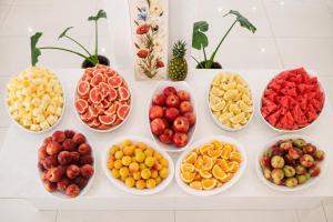 a bunch of bowls of different types of fruit at Corfu Hotel in Ayia Napa +54 photos