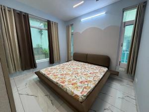 a bedroom with a bed in a room with windows at Potion's Villa - Shimla in Shimla