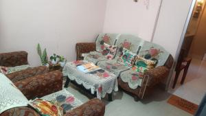 a living room with a couch and a table at SH Homestay in Tezpur