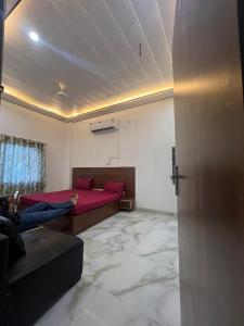a person laying on a bed in a living room at Hotel Jazz Suit Villa in Agra