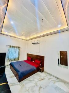 a bedroom with a large bed with red pillows at Hotel Jazz Suit Villa in Agra