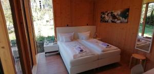 a bedroom with a bed with two dogs on it at HOTEL SPATZENNEST Vogelsberg in Herbstein