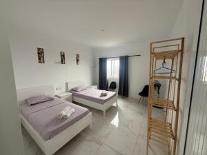 a bedroom with two beds and a ladder in it at MeloMar Rooms in Ponta do Sol
