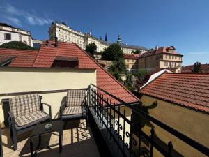 two chairs on the balcony of a building at LH Hotel Golden Wheel in Prague