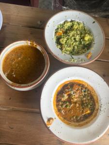 three bowls of food on a wooden table at ART Sattal in Bhīm Tāl +43 photos