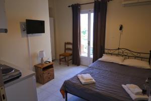 a bedroom with a bed with two towels on it at Themis - Θέμις Apart Hotel in Loutra Edipsou