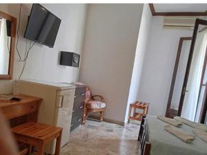 a bedroom with a desk and a tv on the wall at samos town hostel in Samos +12 photos