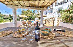 a bottle of wine sitting on a table on a patio at Villa Granadella in Jávea