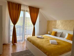 a bedroom with a bed and a large window at Vila Safir MM in Şurdeşti +52 photos