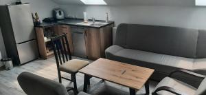a living room with a couch and a table at Noclegi Onesto in Międzybrodzie Bialskie