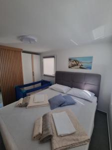 a bedroom with a bed with towels on it at Apartmani 'Cvit' in Karlobag