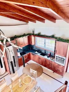 a kitchen with wooden cabinets and a table at Casa Blue in Panayía Mesosporítissa