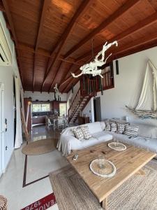 a living room with a couch and a table at Casa Blue in Panayía Mesosporítissa