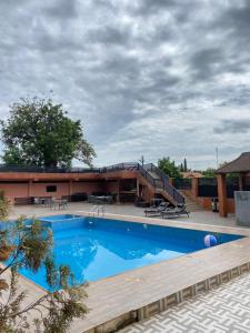 a large swimming pool in front of a building at Peach City Hotel in Prampram