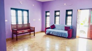 a living room with a couch and a chair at Moonlight mist wayanad in Vaduvanchal