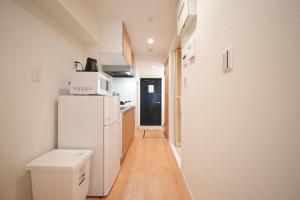 a kitchen with a refrigerator and a microwave at Hotel Otsukahouse in Tokyo +20 photos