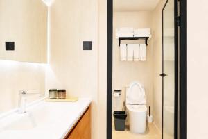 a white bathroom with a toilet and a sink at Houshan Park House in Narat +47 photos