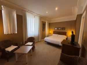 a hotel room with a bed and a table and chairs at Marina de Campios in Comillas