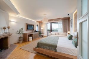 a large bedroom with a large bed and a fireplace at OLEO hotel in Momchilgrad