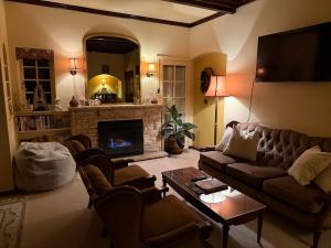 a living room with a couch and a fireplace at Echo Point Cottage in Katoomba