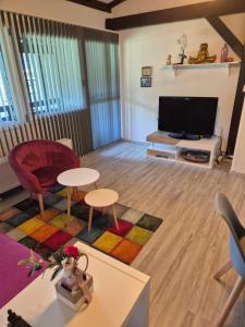 a living room with a couch and a tv at Ferienwohnung Atelier in Siegsdorf