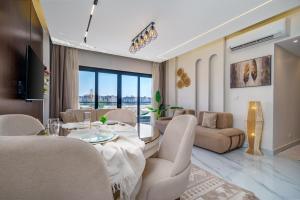 a living room with a dining table and chairs at Luxury Smart Home Entire Apartment with 2 Bedrooms in Madinaty in Madinaty