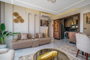 a living room with two couches and a glass table at Luxury Smart Home Entire Apartment with 2 Bedrooms in Madinaty in Madinaty